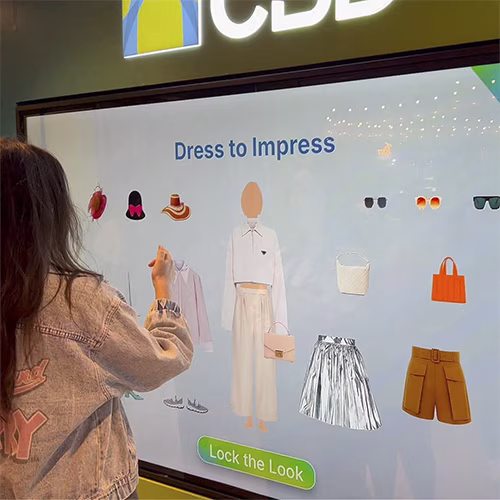 People playing a multi-level interactive financial literacy game at a brand activation event in Dubai, learning how to save and invest money.