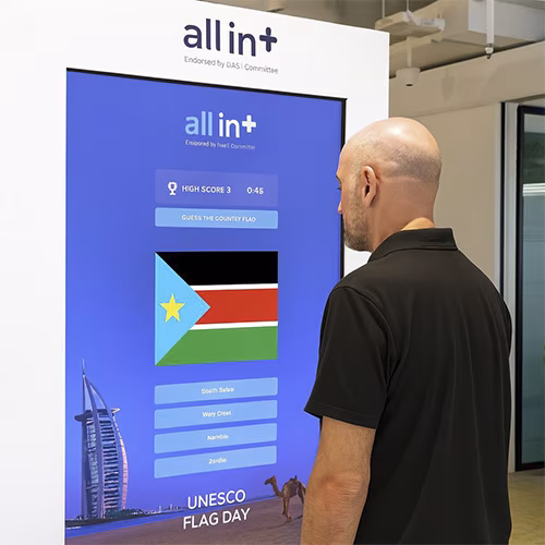 Participants playing the interactive Guess the Flag game at an event, engaging with a fun, branded quiz experience that tests geographical knowledge in a lively setting.