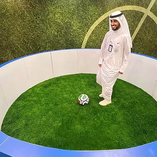Custom-branded Interactive Football Arena setup at a Dubai exhibition venue with an electronic leaderboard for competition
