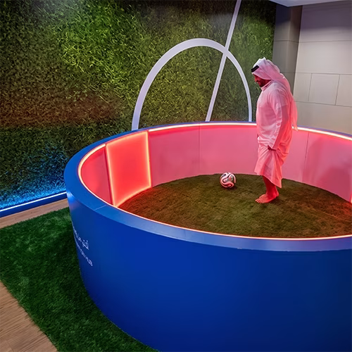 Custom-branded Interactive Football Arena setup at a Dubai exhibition venue with an electronic leaderboard for competition