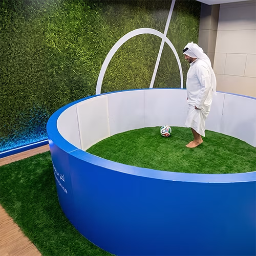 Custom-branded Interactive Football Arena setup at a Dubai exhibition venue with an electronic leaderboard for competition