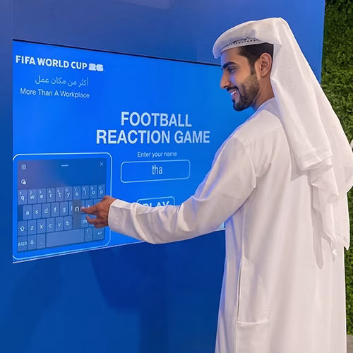 Custom-branded Interactive Football Arena setup at a Dubai exhibition venue with an electronic leaderboard for competition