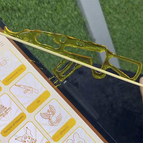 Guests using the AI Sugar Painting Robot in UAE, watching it create edible art and enjoying unique designs at events, kids activities, and parties.
