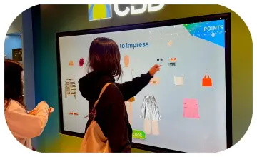 People playing a multi-level interactive financial literacy game at a brand activation event in Dubai, learning how to save and invest money.