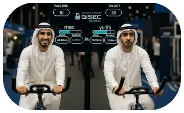 Guests racing on interactive bike game at corporate event in Dubai